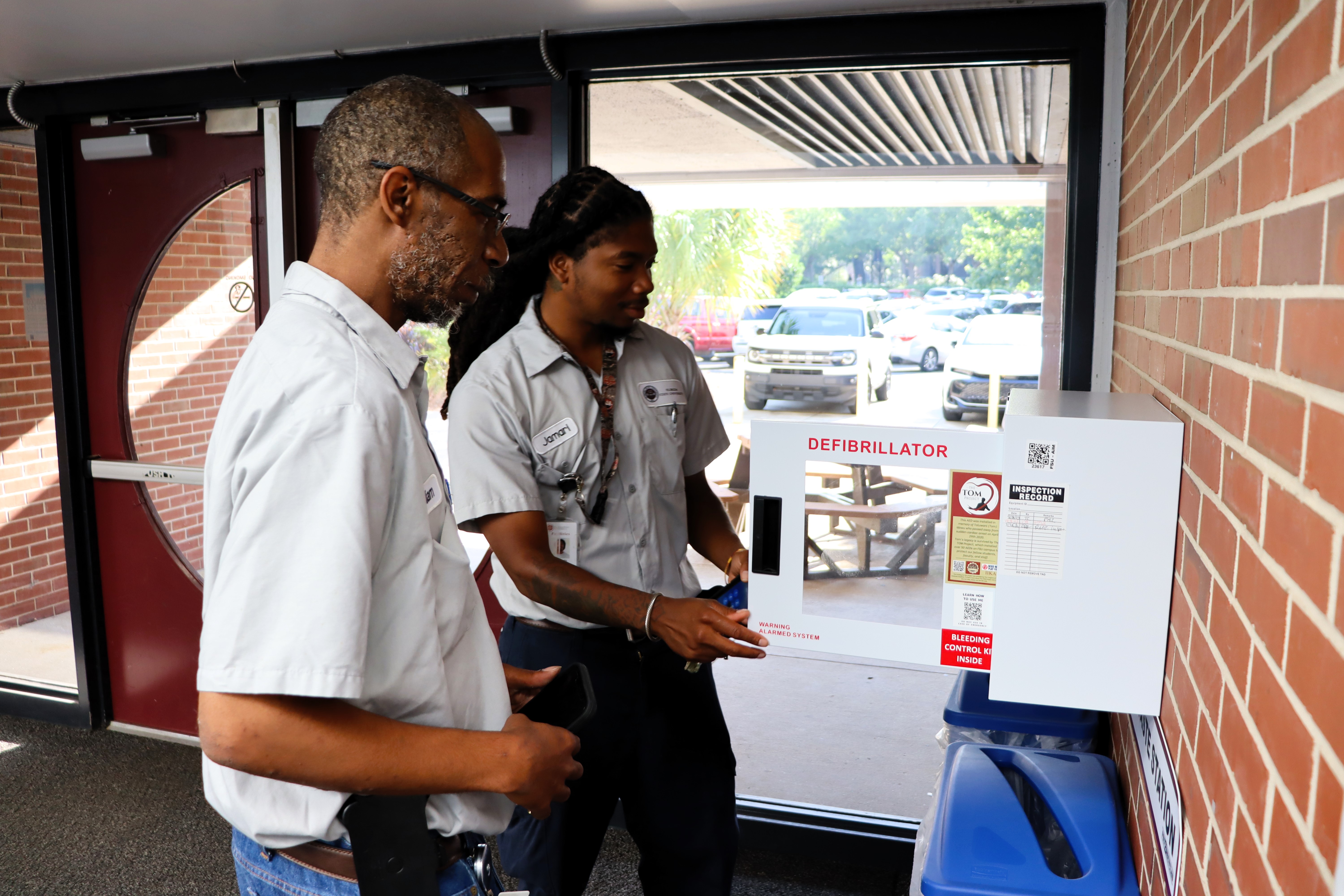 Facilities PM teams perform a quarterly inspection on an AED unit.